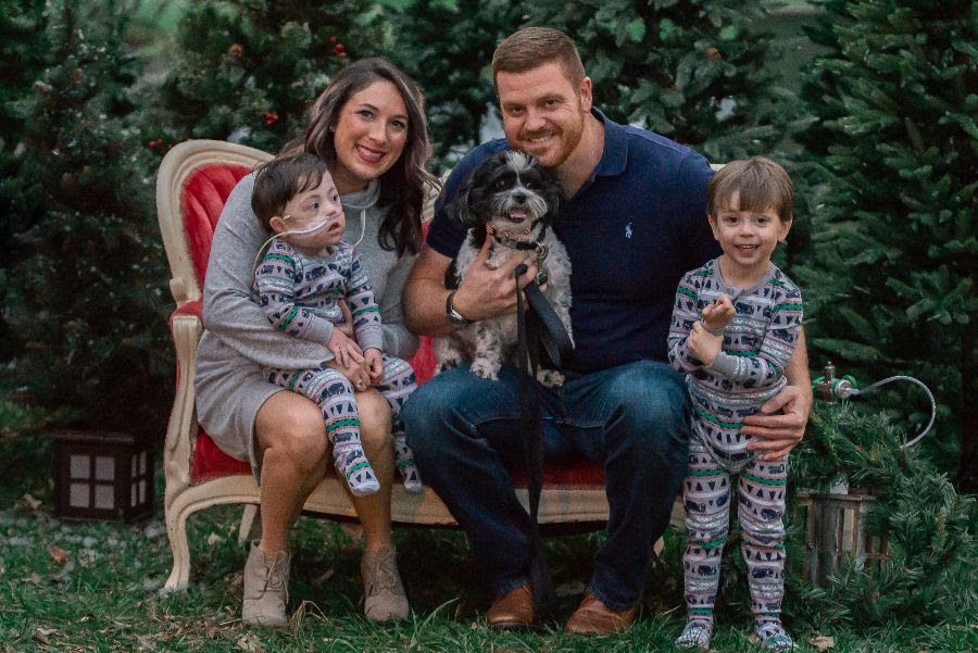 Wally's family poses for a photo. Pictured are mom, Julianna, dad, Tyler, three-year-old brother, Braxton, and dog, Tank.