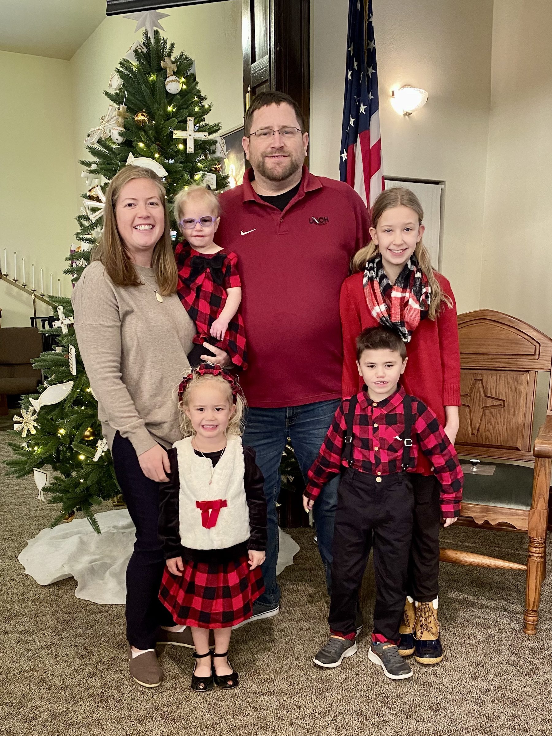 The whole family in front of the tree at the holidays