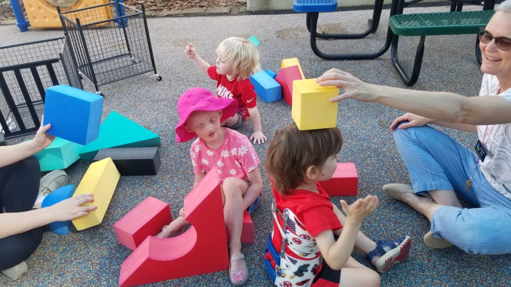 Children playing with blocks outside