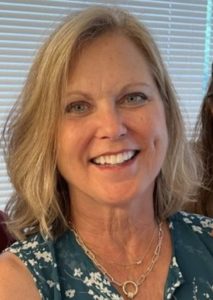 Woman with blonde hair is smiling.