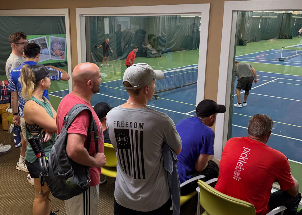 Fans watch the pickleball tournament from the viewing area.