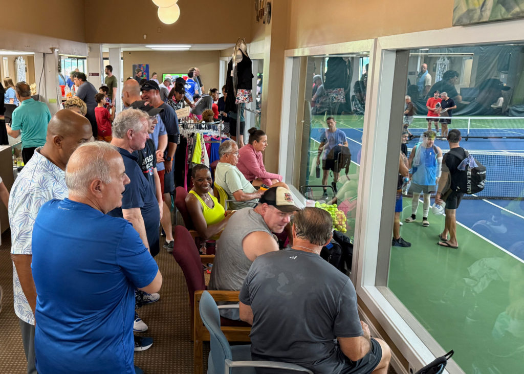 Fans watch the pickleball tournament from the viewing area.