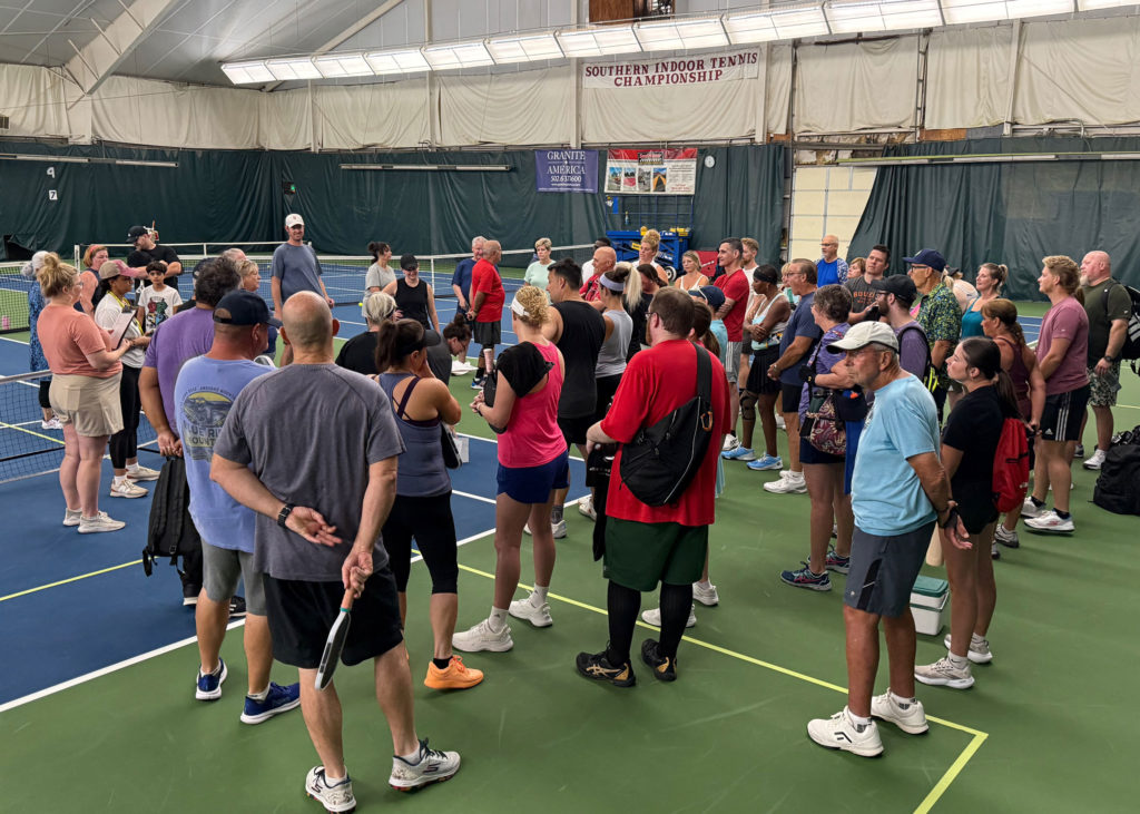 Pickleball tournament players gather before play begins.