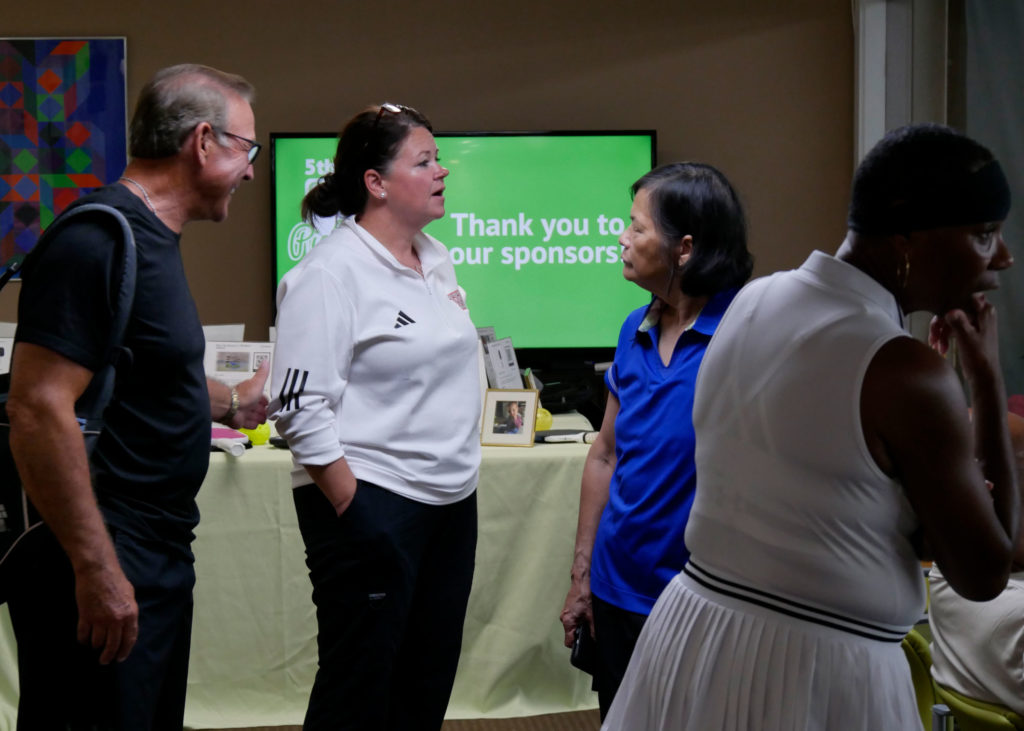 Pickleball tournament director Chrissy Haywood talks to tournament participants.