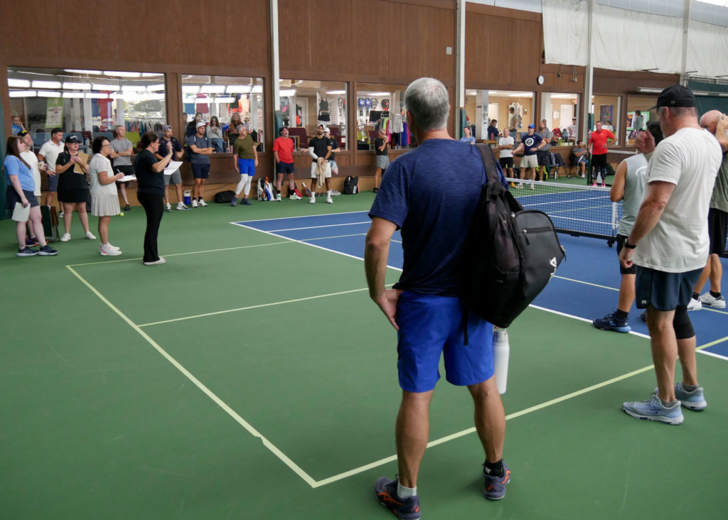 Pickleball tournament players gather before play begins.