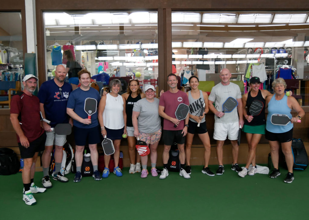 Pickleball tournament players pose for a group photo before play begins.
