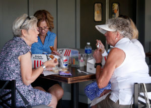 Four woman enjoying the KFC box lunches before the golf scramble begins.