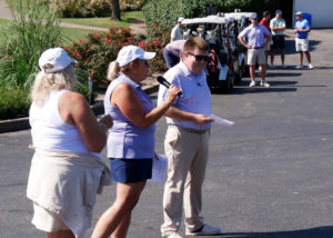 Diane Nelson, Debbie Baldwin, and Josh Griffin addressing the golfers.