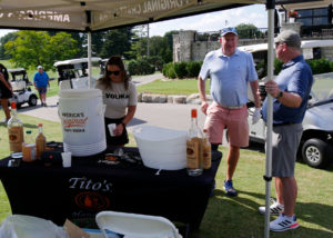 Two men at the Tito's Vodka tent waiting for a cocktail.