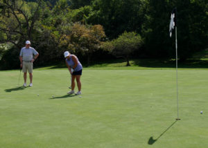 Debbie Baldwin puts while her teammate watches.