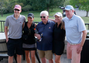 Tom Briggs and his friends pose for a photo on the patio.
