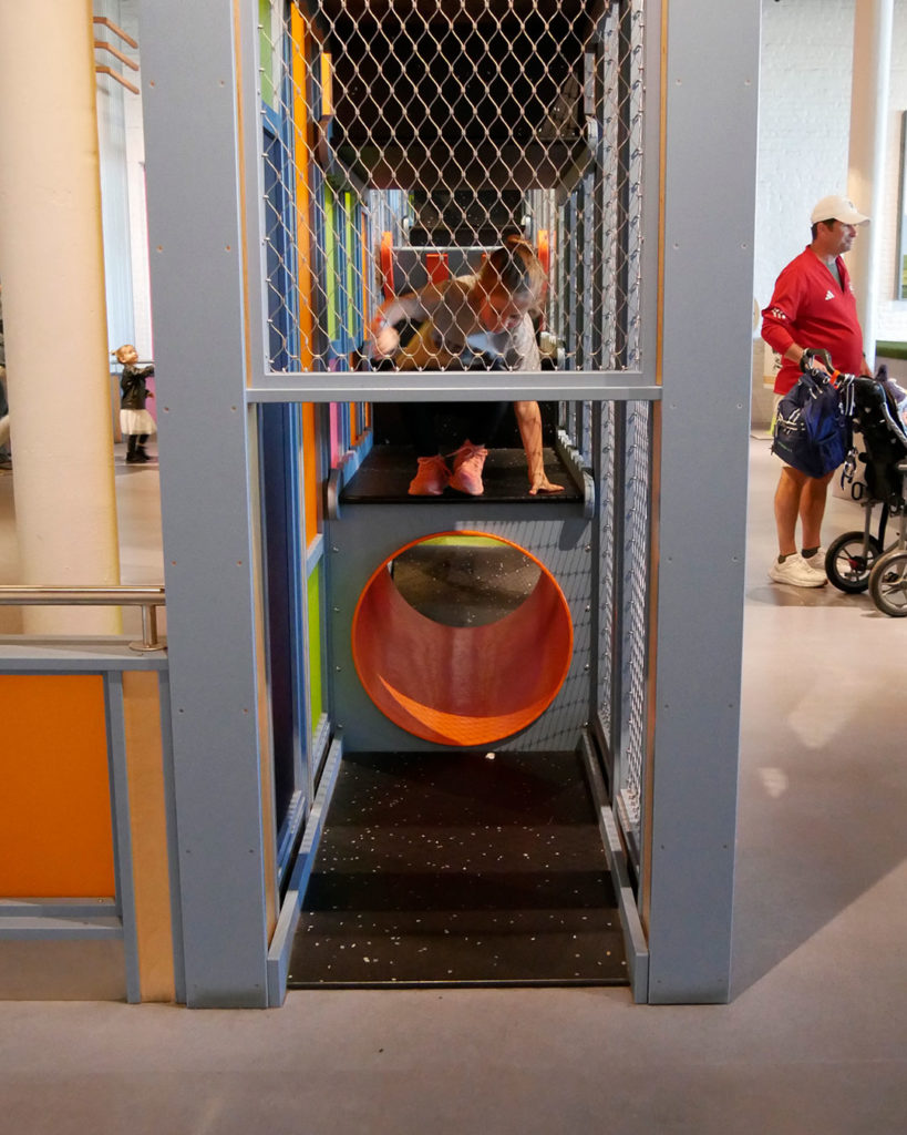 A girl is about to jump from a vertical obstacle course at the Kentucky Science Center.