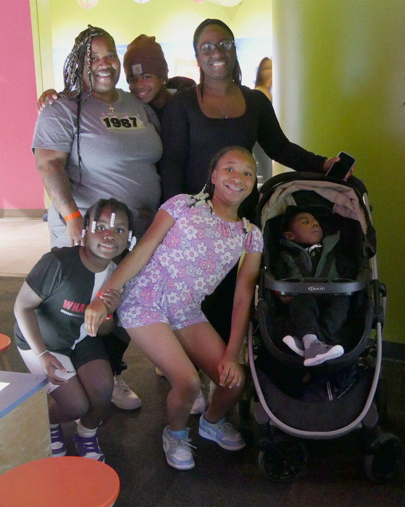 A family poses for a photo at the Kentucky Science Center.