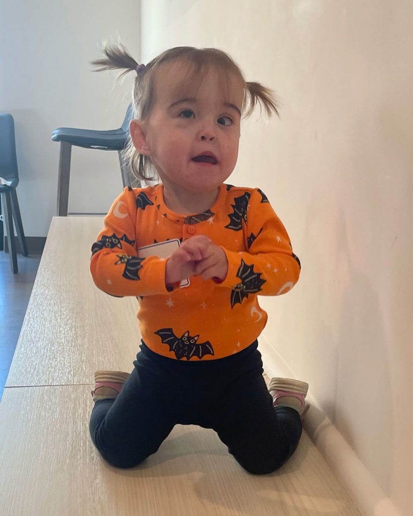 A small girl poses for a photo.