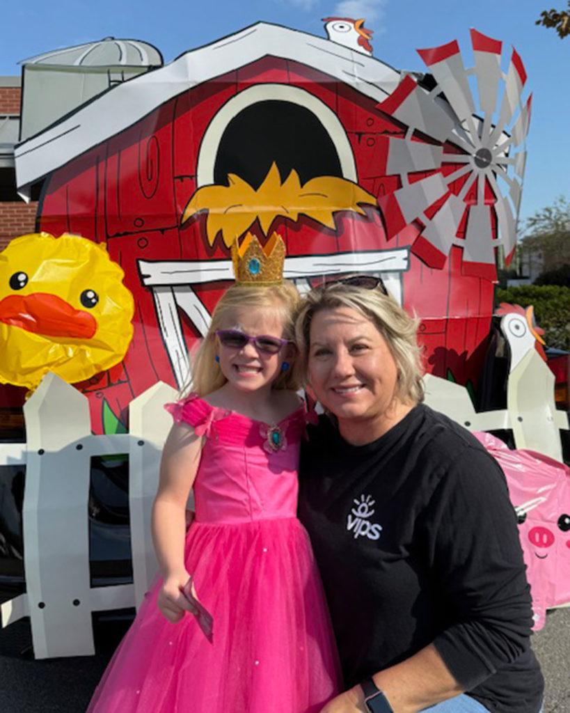 Tammy Maynard and former VIPS child Vivian pose for a photo.