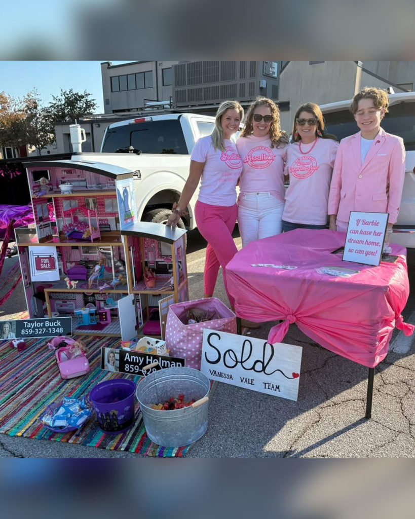 Realtors from the Vanessa Vale Team pose for a photo with their Barbie-themed display.