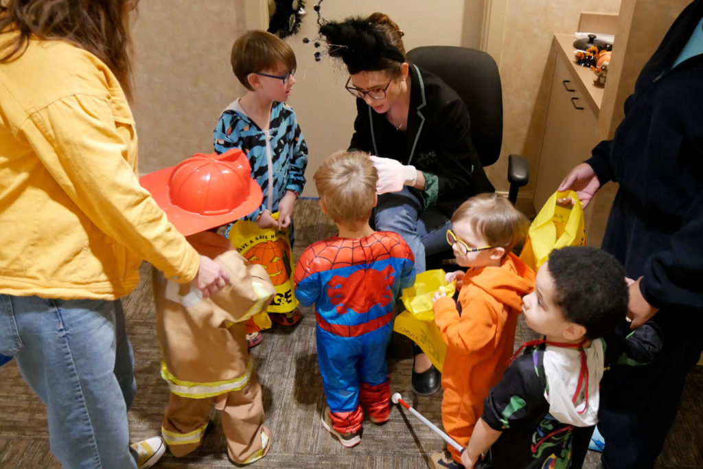 Miss Paige hands out treats to the kids.