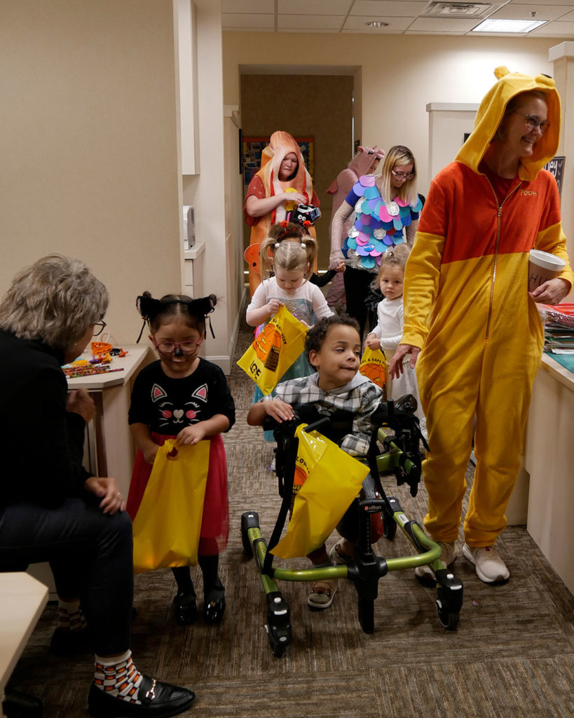 The kids make their way through the teacher's office area.