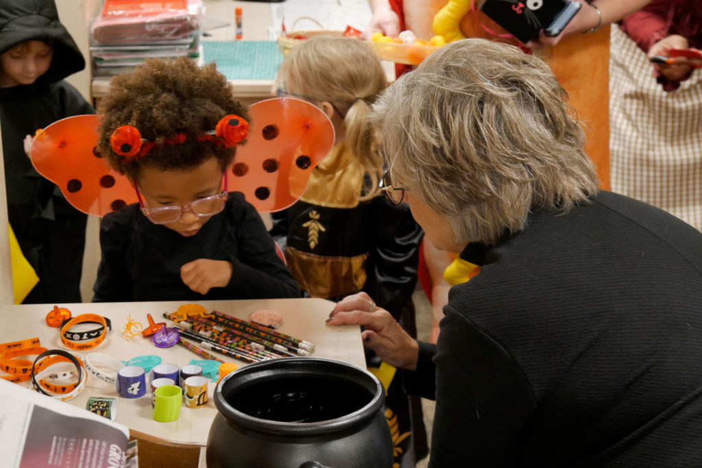 A ladybug picks out a treat from Miss Kathy's desk.