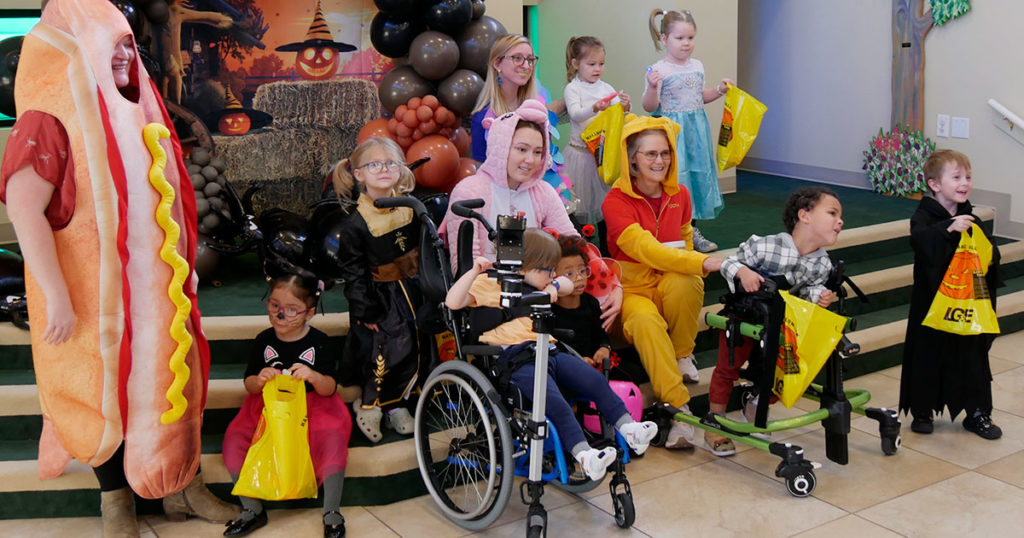 Miss Staci's class poses for a photo on the steps in Kids Town.