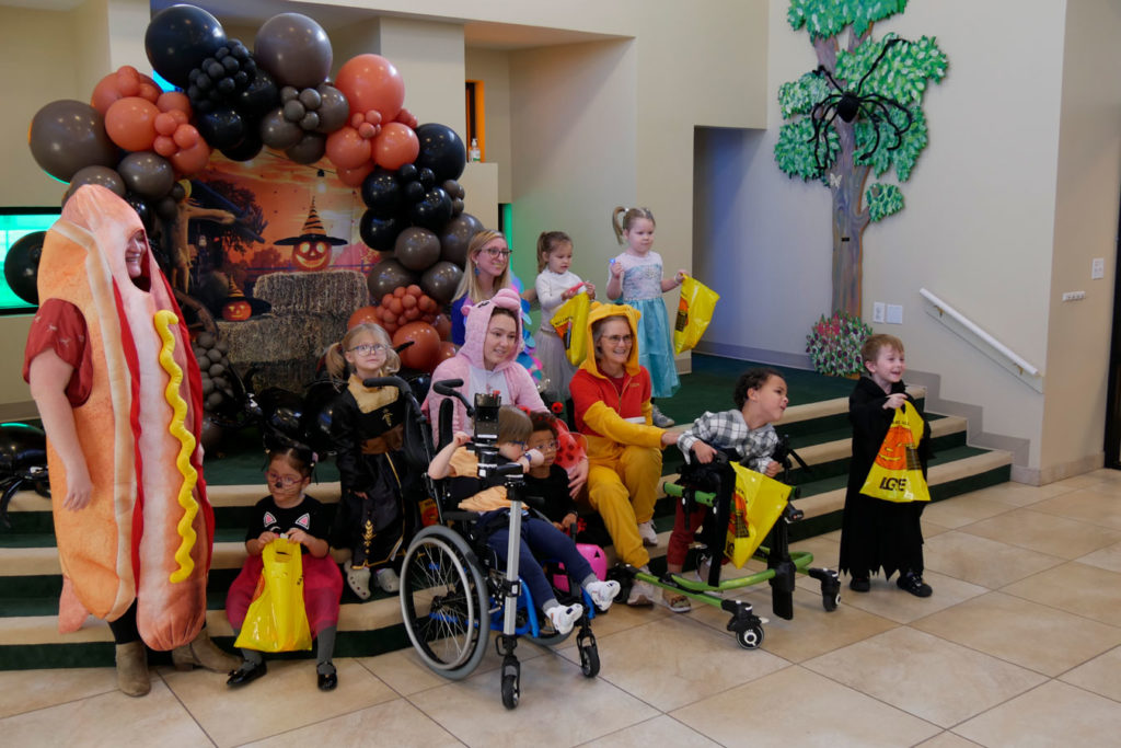 Miss Staci's class poses for a photo on the steps in Kids Town.