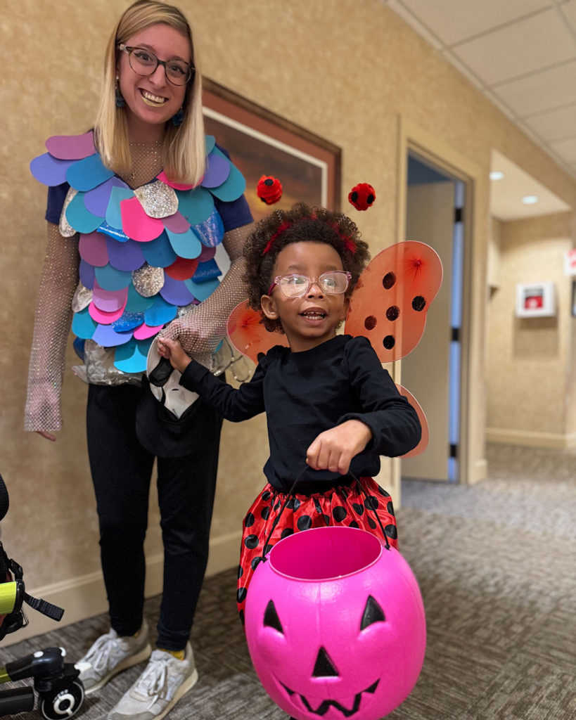 Miss Haylie and a ladybug pose for a photo.