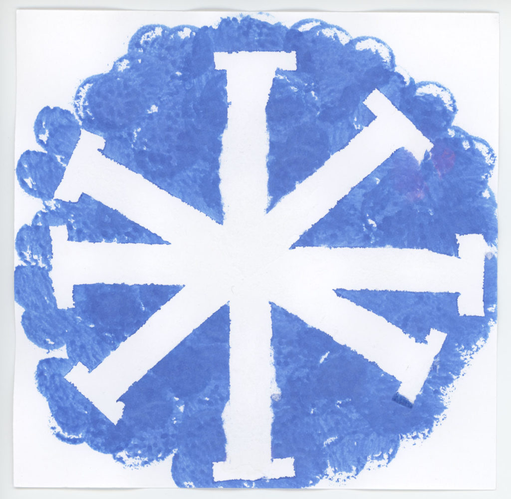 A child-made blue flourette shape with a snowflake in the center, reversed out in white.