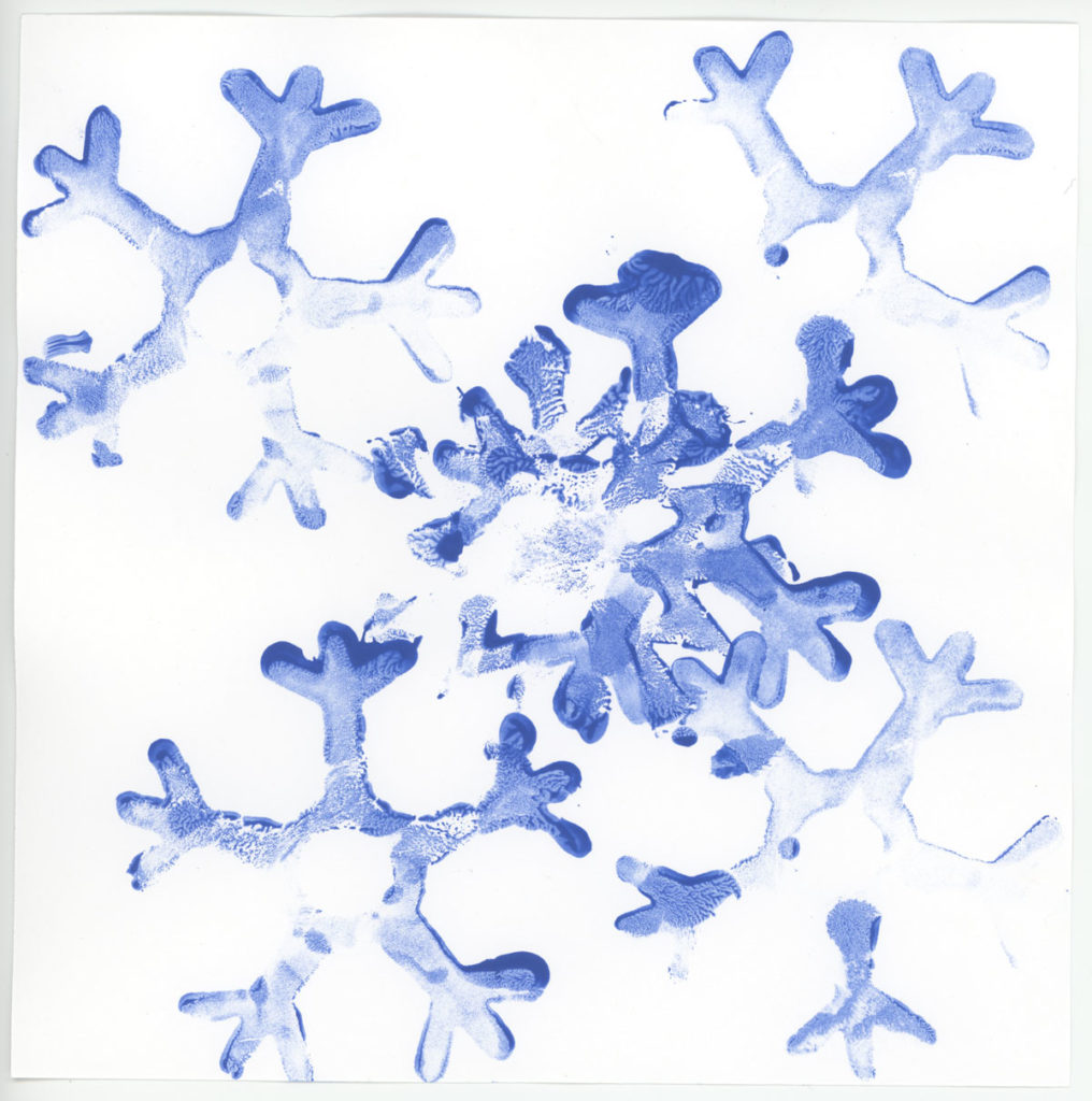 Child-made snowflakes created a shaped stamp and blue ink.