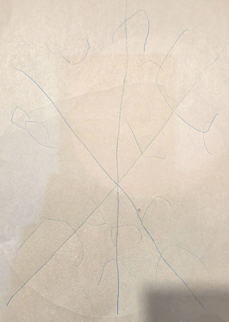 A child-made snowflake with six points and semicircles on the ends drawn with blue marker.