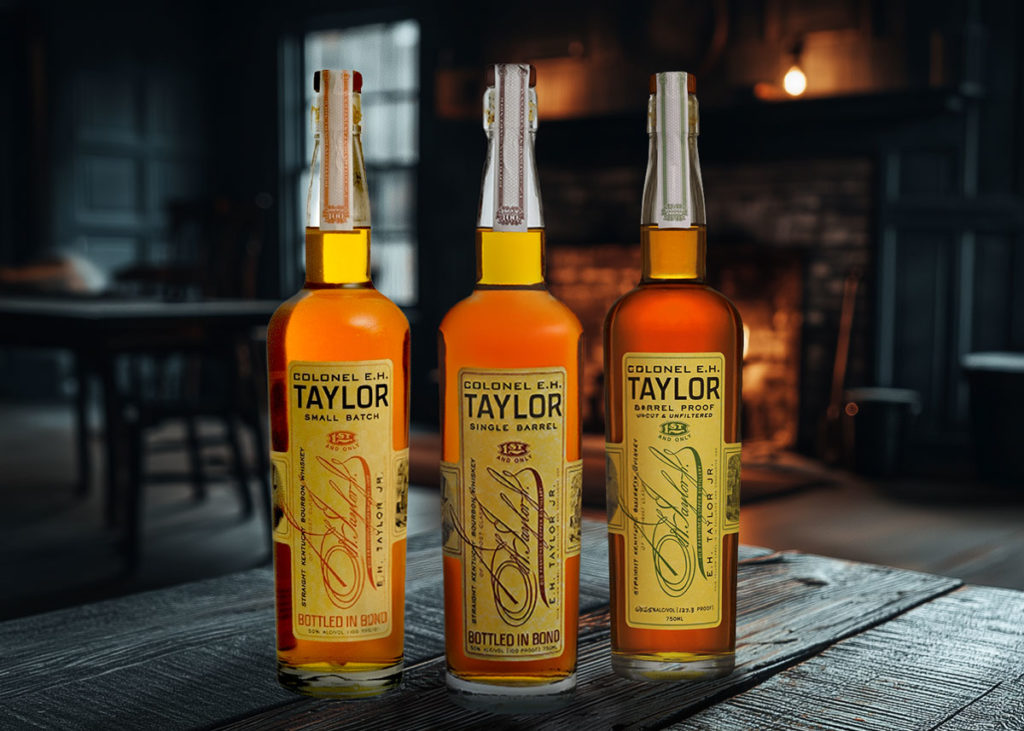 Three bottles of Colonel E.H. Taylor, Jr. Bourbon on a table.