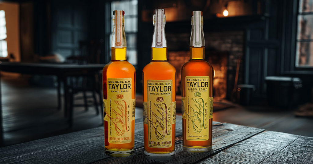 Three bottles of Colonel E.H. Taylor, Jr. Bourbon on a table.