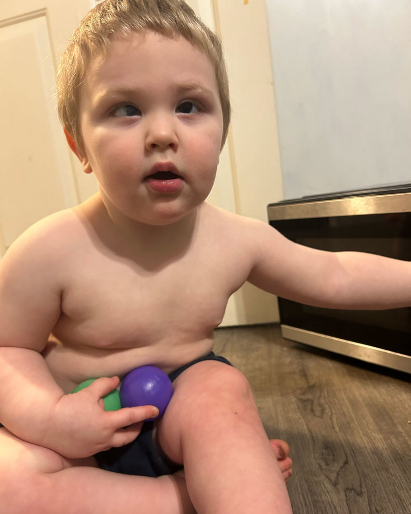 Phoenix is sitting on the floor and posing for a photo.