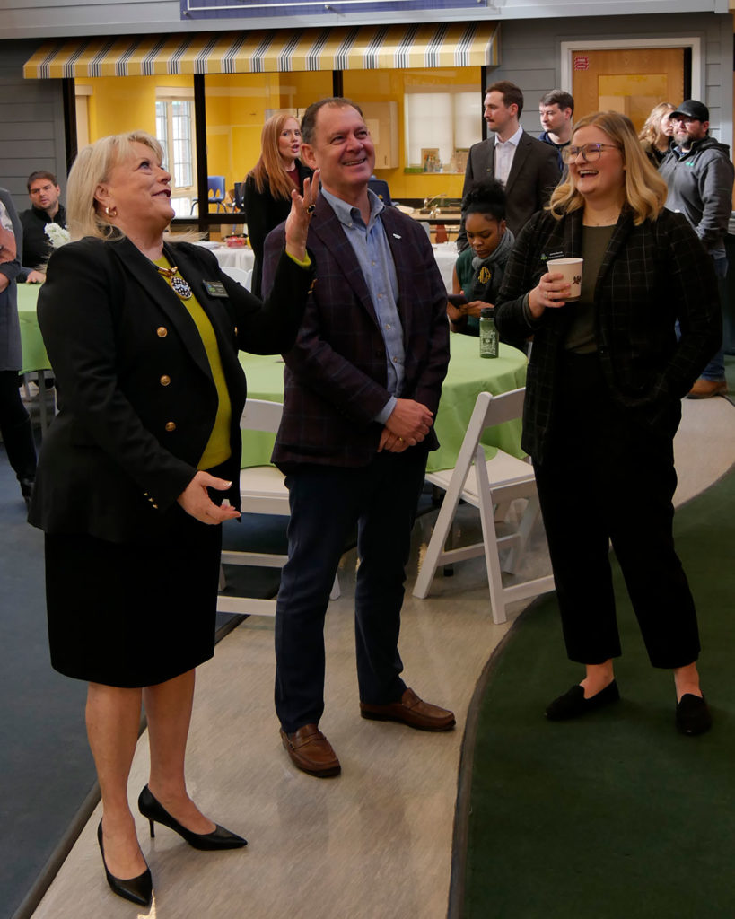 Diane Nelson, Logan Pichel, and Justine Aycock chat during the reception.
