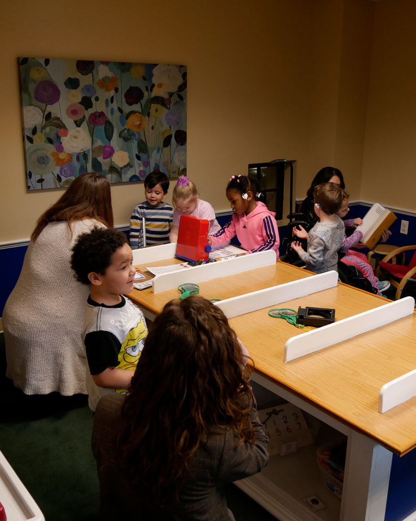 Preschoolers play in the banking center in Kids Town.