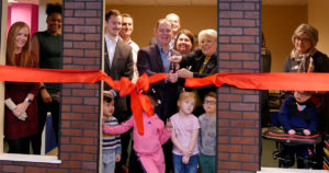 The teams from Republic Bank and VIPS, along with the preschoolers, cut the red ribbon.