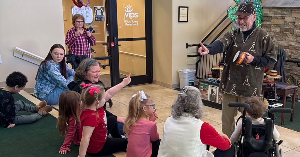 Gregory counts drums with the kids in Kids Town.