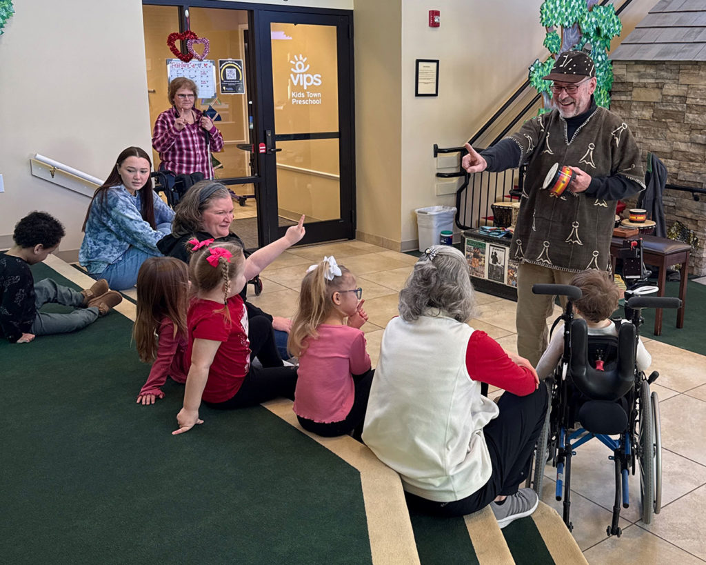Gregory counts drums with the kids in Kids Town.