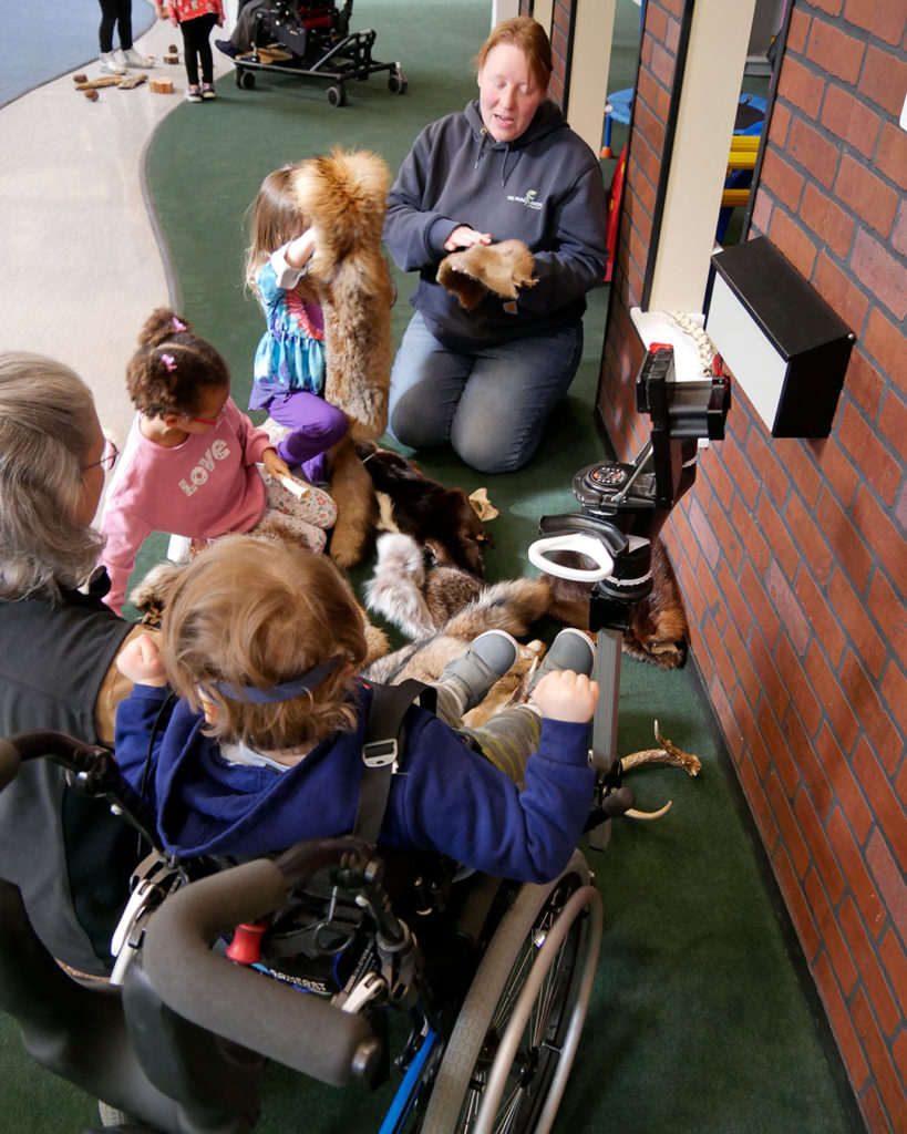 Ranger Erin shows the kids animal pelts she brought to share.