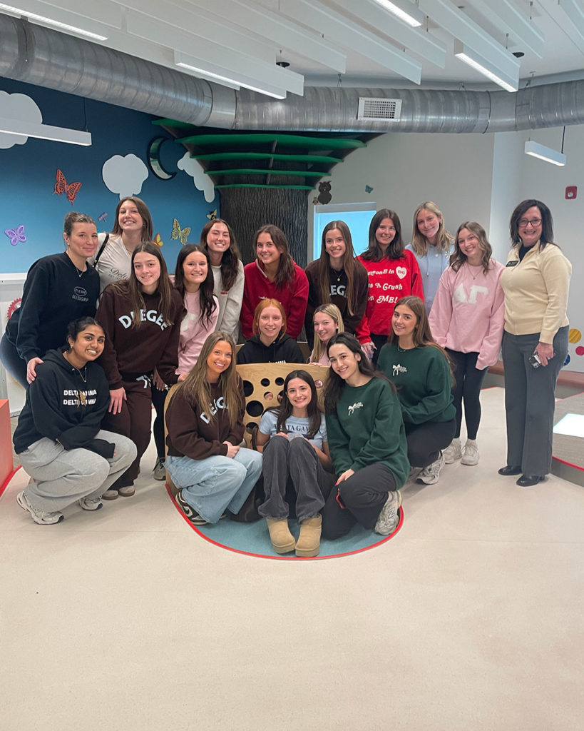 Delta Gammas pose for a group photo while taking a tour of the FRC.