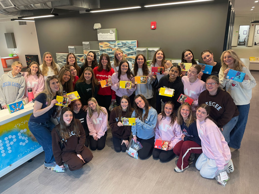 All the Delta Gammas pose for a group photo along with the cards they made.
