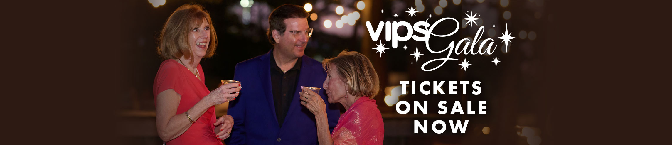 Three adults chatting at the 2025 Gala with VIPS Gala logo with "Tickets On Sale Now" text on the right.
