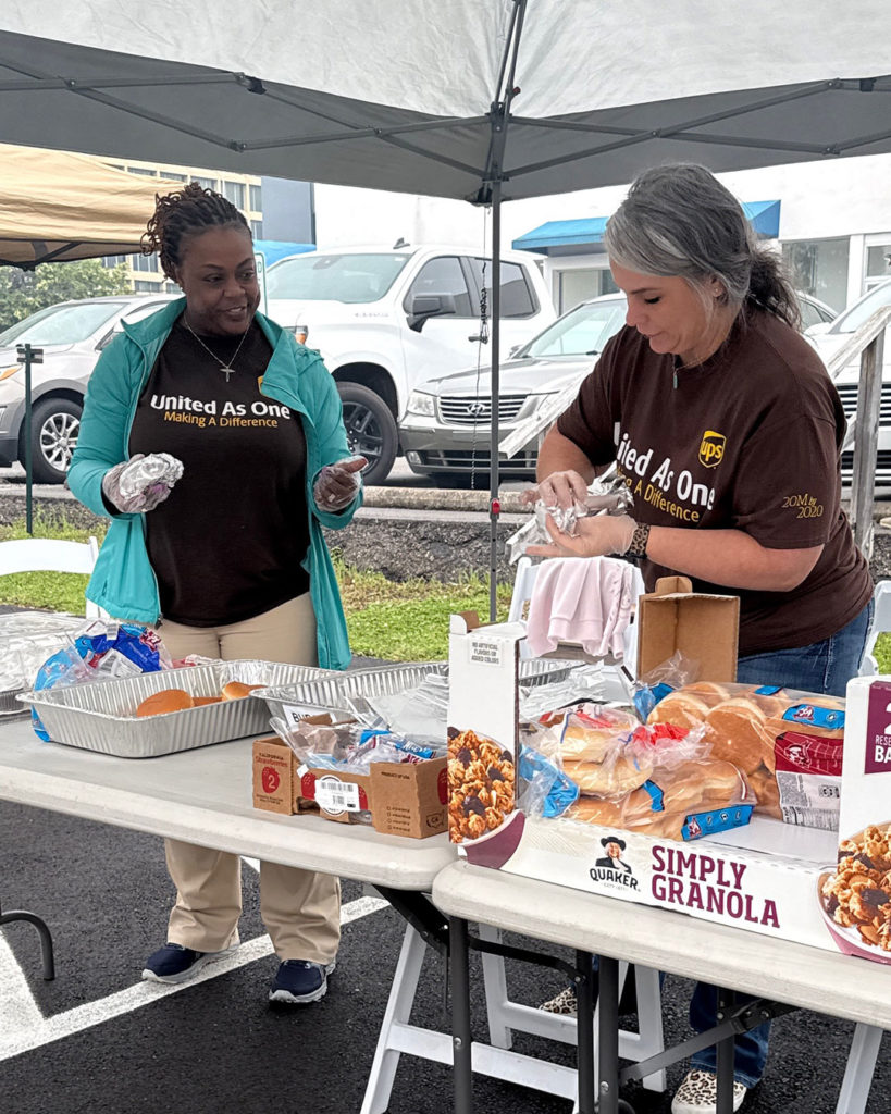 Volunteers from UPS assemble burgers at the Cookout for the Crusade.