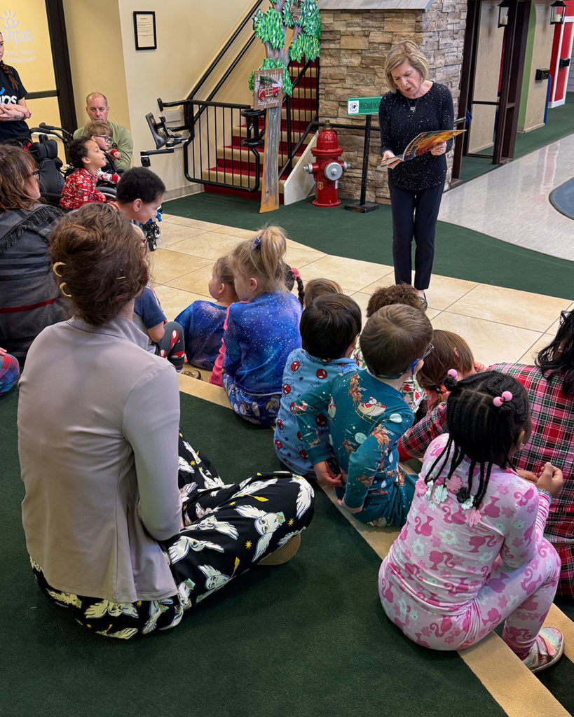 Sharon Bensinger reads Hanukkah Bear to students in Kids Town.