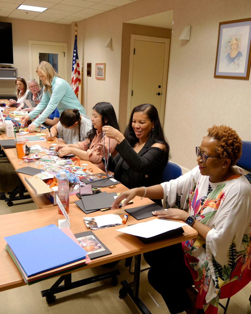 GE volunteers fill the conference room and assemble thank you cards.