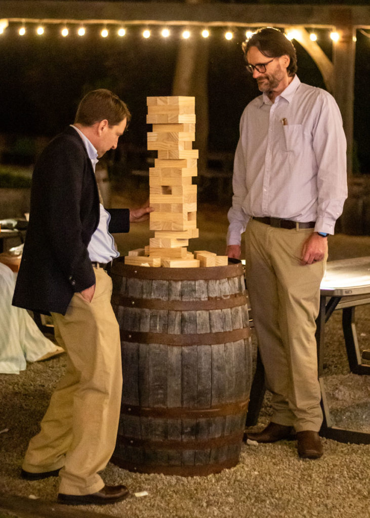 Two men play a block-stacking game during the Gala after-party.