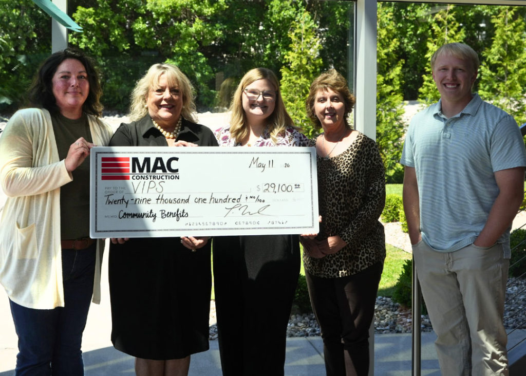 Diane Nelson, Justine Aycock, and MAC Construction staff members pose for a photo with a giant check for $29,100.