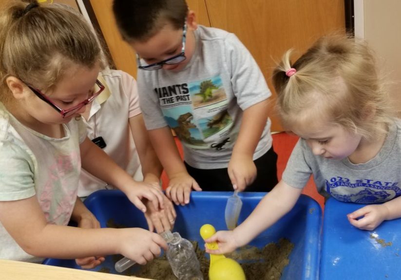 Children making a volcano in class